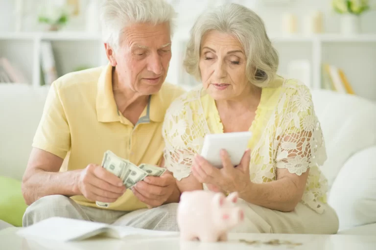 Elderly couple reviewing senior living financial plans with their family